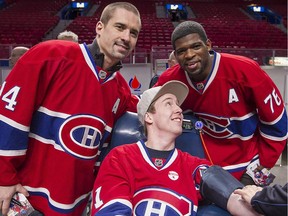 The Canadiens' Tomas Plekanec and P.K. Subban pose with fan Sébastien Lavoie during the team's annual blood-donor clinic at the Bell Centre on Nov. 25, 2014.
