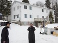 Members of the ultra-orthodox Jewish sect Lev Tahor, stand and take photos outside their home with their furniture as they wait for a moving truck to arrive in the town of Sainte-Agathe-des-Monts, 100 kilometres north of Montreal, on Tuesday, November 26, 2013. Over 200 members of the sect, which is led by Rabbi Shlomo Helbrans, left their homes in Quebec for Ontario amid allegations of neglect by youth protection services.