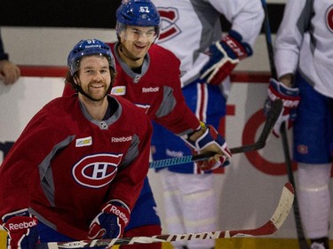 Montreal Canadiens center David Desharnais, left, and Montreal Canadiens left wing Max Pacioretty  share a laugh as they get ready to run drills during a team practice at the Bell Sports Complex  in Montreal on Thursday November 27, 2014.