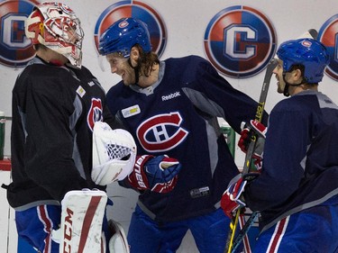 Montreal Canadiens goalie Carey Price, left to right, Montreal Canadiens defenseman Tom Gilbert and Montreal Canadiens defenseman Mike Weaver joke around during a break at team practice at the Bell Sports Complex  in Montreal on Thursday November 27, 2014.