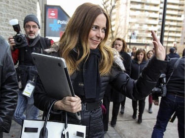 Pierre Karl Péladeau's partner Julie Snyder waves to cameramen and reporters gathered outside Parti Québécois headquarters in Montreal Thursday November 27, 2014.