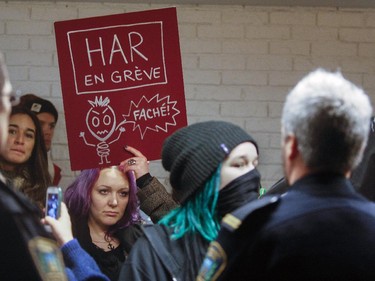 Protesters march past the amphitheatre where Pierre Karl Péladeau delivered a speech to students at Université de Montréal Thursday November 27, 2014.