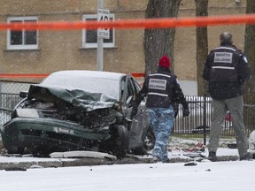 Police at the site of a fatal accident on Maurice Duplessis near Langelier in Montreal, Nov. 28, 2014. The driver crashed into a tree and died after colliding with several cars. Police suspect he was fleeing after robbing a Super C supermarket nearby.