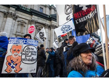 People take part in an anti-austerity protest in downtown Montreal on Saturday, November 29, 2014.