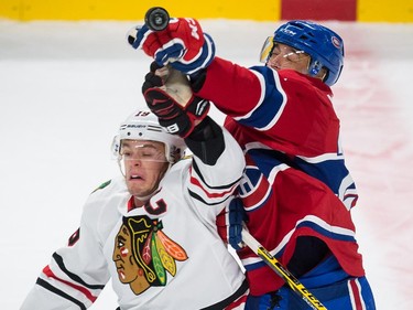 Chicago Blackhawks centre Jonathan Toews and Montreal Canadiens centre Manny Malhotra, battle for the puck during the first period at the Bell Centre in Montreal on Tuesday, Nov. 4, 2014.
