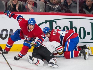 Montreal Canadiens defenseman Mike Weaver, left, and teammate Michael Bournival tangle with Chicago Blackhawks right wing Kris Versteeg during the first period at the Bell Centre in Montreal on Tuesday, Nov. 4, 2014.