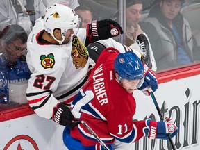MONTREAL, QUE.: NOVEMBER 4, 2014 -- Montreal Canadiens right wing Brendan Gallagher, right, collides with Chicago Blackhawks defenceman Johnny Oduya, left, during the third period of their NHL hockey match at the Bell Centre in Montreal on Tuesday, November 4, 2014. (Dario Ayala / Montreal Gazette)
