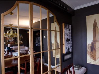 A mirror, possibly an old window, at end of dining area.
