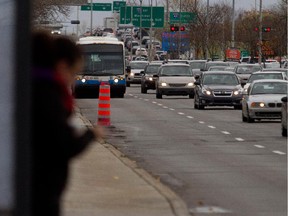 A commuter waits for STM bus 209 on Sources Blvd. on Friday Nov. 7, 2014.  The STM is to launch a new reserved bus lane along the boulevard.