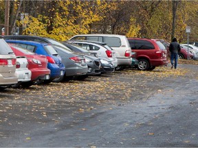 A motorist walks to his car in the Ste-Anne de-Bellevue 24-hour free parking lot on Friday Nov. 7, 2014.  A commuter has complained that students from John Abbott College are parking their cars in the lot at the Ste-Anne-de-Bellevue AMT station and walking to the school.