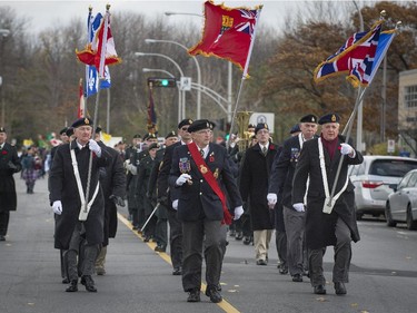 Canadian veterans march to the Pointe Claire Cenotaph for memorial day services on Sunday, Nov. 9, 2014.
