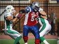 MONTREAL, QUE.: OCTOBER 13, 2014 -- Montreal Alouettes offensive lineman Jeff Perrett takes on two Saskatchewan Roughrider defenders during Canadian Football League game in Montreal Monday October 13, 2014.  (John Mahoney  / THE GAZETTE)