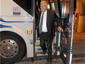 Former Boston Bruin Johnny Bucyk exits team bus in the garage at the Bell Centre before game against the Canadiens on Oct. 16, 2014.