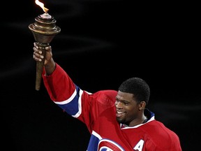 Canadiens defenceman P.K. Subban raises the torch during ceremony before home opener at the Bell Centre against the Boston Bruins on Oct. 16, 2014.
