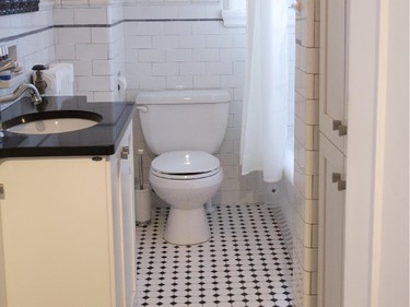 The bathroom has the original ceramic floor and wall tiling.
