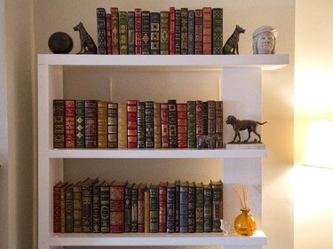 A bookshelf with leather-bound books.