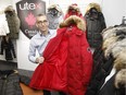Michael Seligman , president of Utex standing in his showroom while holding a red winter coat  on display on October 24, 2014. After 70 years, it looked as if the Utex brand was destined for extinction. But Michael Seligman thought there was still a future for one of the oldest clothing-industry names in Canada, and bought the licensing rights to Utex for women's outerwear.
