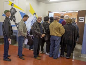 Voters lined up and waited as long as 1 and a half hours to vote at St. Monica Elementary School during the advance polls for school board election in Montreal, on Sunday, October 26, 2014.