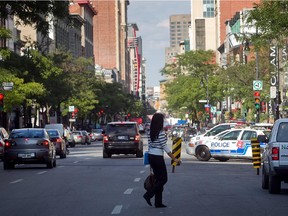 A woman crosses  Ste. Catherine St. near Mackay on Monday September 15, 2014. Montreal has announced details for a revamp of Ste. Catherine street, between Atwater and Bleury.