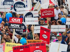 In this file picture from November of 2014, protesters march down Montreal's Berri St. in a demonstration against Quebec's municipal pension reform bill. The city of Montreal announced this week it is looking to cut overall remuneration to its municipal employees by 10.5 per cent by reducing benefits, adding working hours, contracting out work and paying less for sick days.