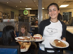 Waitress Rebecca Fuentes with a breakfast order at Beautys on Mont-Royal Ave.