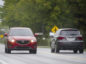 Motorists drive along Boulevard Cité des Jeunes between Montée Labossière and St. Louis in Saint Lazare west of Montreal, Sunday, September 21, 2014.