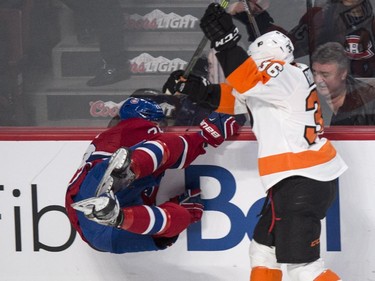 Montreal Canadiens' Nathan Beaulieu slams into the boards as he is checked by Philadelphia Flyers' Zac Rinaldo during second period NHL hockey action Saturday, November 15, 2014 in Montreal.