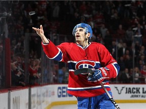 The Canadiens' Rene Bourque throws a puck into the crowd after being named the first star of the game against the New York Rangers during Game 5 of the Eastern Conference final at the Bell Centre on May 27, 2014.