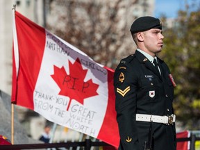 A soldier in the Canadian Army stands guard at the National War Memorial during a ceremony at the memorial on October 24, 2014 in Ottawa, Canada.  Two days previously, a gunman killed Cpl. Nathan Cirillo, a soldier guarding the memorial.