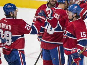 Montreal Canadiens' P.A. Parenteau, right, celebrates his team's 6-3 victory over the Philadelphia Flyers with teammate Nathan Beaulieu in NHL hockey action Saturday, November 15, 2014 in Montreal.