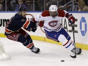 Montreal Canadiens' P.K. Subban, right, and New York Rangers' Dan Boyle chase the puck during the second period of the NHL hockey game, Sunday, Nov. 23, 2014, in New York.