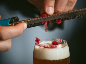Four of Montreal’s best bartenders have each conjured a new drink for this season of ice and snow. Here John-Bruce Mathieu adds cranberry shavings on top of his Reindeer Runner cocktail.