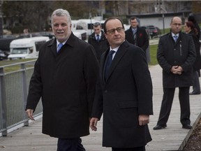 Quebec Premier Philippe Couillard and French President François Hollande arrive at Bassin Brown in Quebec City for a presentation with Université Laval Tuesday Nov. 4, 2014.