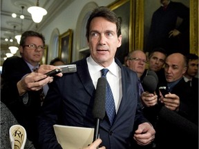 Quebec Opposition MNA Pierre Karl Péladeau is surrounded by reporters as he arrives at a caucus meeting, Tuesday, Nov. 18, 2014 at the legislature in Quebec City. Péladeau had to answer questions over his comments on the Bloc Québécois.