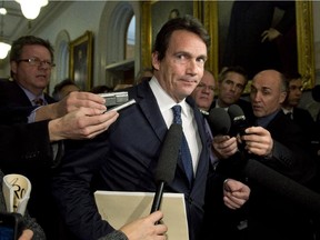 Quebec Opposition MNA Pierre-Karl Péladeau is surrounded by reporters as he arrives at a caucus meeting, Tuesday, November 18, 2014 at the legislature in Quebec City. Péladeau had to answer questions over his comments on the Bloc Quebecois.