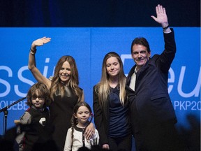 Pierre Karl Peladeau waves to supporters alongside his family in Saint-Jerome, Que., Sunday, November 30, 2014 where he officially launched his bid to become leader of the Parti Quebecois.