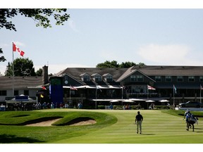 MONTREAL, QC - JULY 24:  Retief Goosen of South Africa and Tim Clark of South Africa walk to the ninth green during the first round of the RBC Canadian Open at the Royal Montreal Golf Club on July 24, 2014 in  Montreal, Quebec, Canada.