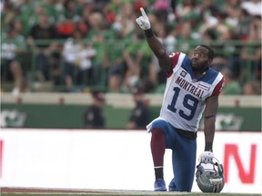 Montreal Alouettes slotback S.J. Green points to the large screen after a play is under review against the Saskatchewan Roughriders during the third quarter of CFL football action on Saturday, August 16, 2014 in Regina.