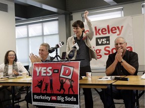 Campaign manager Sara Soka, centre, celebrates with fellow supporters after the passing of Measure D, imposing a sales tax on soda drinks, Wednesday, Nov. 5, 2014, in Berkeley, Calif. Berkeley voters became the first in the country to approve taxing sodas to curb consumption, after costly campaigns by the soda industry helped defeat similar taxes in more than 30 other cities and states in recent years.