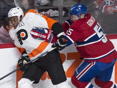 Philadelphia Flyers' Wayne Simmonds is checked by Montreal Canadiens' Sergei Gonchar during first period NHL hockey action Saturday, November 15, 2014 in Montreal.