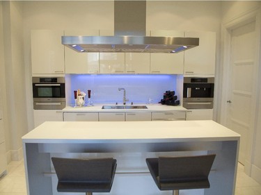 The kitchen on the first floor of Penthouse 1250 at the Ritz-Carlton boasts a Poggenrpohl kitchen with LED backsplash, Miele appliances and a retractable hood. (Vincenzo D'Alto / Montreal Gazette)