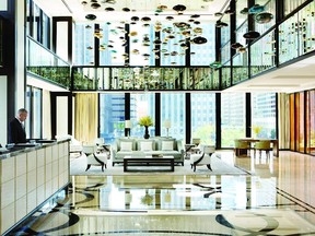 The lobby of The Langham, Chicago, is a vision in luxurious white marble, leather furniture and original art, with many interiors designed by Dirk Lohan, the grandson of the architect Mies van der Rohe.