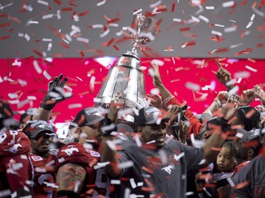The top of the Grey Cup breaks as the Calgary Stampeders celebrate their win against the Hamilton Tiger-Cats during the 102nd Grey Cup in Vancouver, B.C. Sunday, Nov. 30, 2014.
