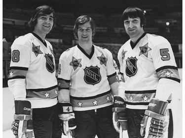 Three future Hall of Famer defencemen pose before a 1970s NHL All-Star Game. Montreal Canadiens' Serge Savard (left) and Guy Lapointe (right) flank Boston Bruins' Bobby Orr.