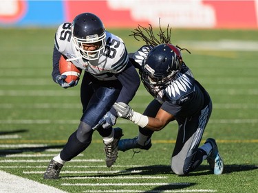 Jerald Brown #39 of the Montreal Alouettes tries to tackle John Chiles #85 of the Toronto Argonauts during the CFL game at Percival Molson Stadium on November 2, 2014 in Montreal. The Montreal Alouettes defeated the Toronto Argonauts 17-14.