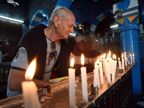 A Jewish pilgrim lights a candle in the Ghriba synagogue on the Tunisian resort island of Djerba at the start of a three-day annual pilgrimage, on May 16, 2014. Pilgrims arrived at Tunisia's Ghriba synagogue, the oldest in Africa, expressing hope that this year would mark a turning point for the ritual despite a rise in Islamist unrest since the 2011 revolution.