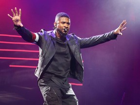 Usher performs in concert during his 'UR Experience Tour 2014' at the Wells Fargo Center on Tuesday, Nov. 11, 2014, in Philadelphia.