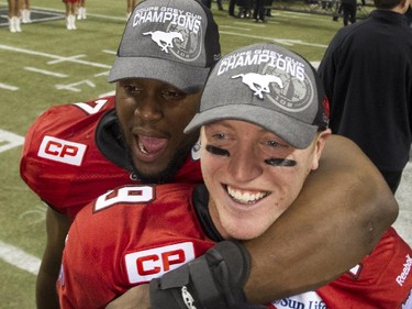 Calgary Stampeders Junior Tate, left hugs quarterback Bo Levi Mitchell, right after winning CFL's 2014 Grey Cup Championship game at BC Place Stadium  in Vancouver, B.C. Sunday November 30, 2014. The Stampeders edged the Hamilton Tiger-Cats 20-16.