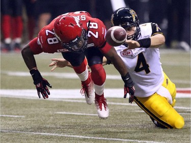 Calgary Stampeders Brandon Smith works to recover the ball along with Hamilton Tiger Cats QB Zach Collaros during the 2014 Grey Cup in Vancouver on Sunday November 30, 2014.