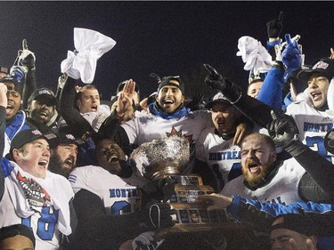 Players from the Montreal Carabins celebrate with the Vanier Cup after beating the McMaster Marauders in the CIS football final in Montreal Saturday, November 29, 2014.